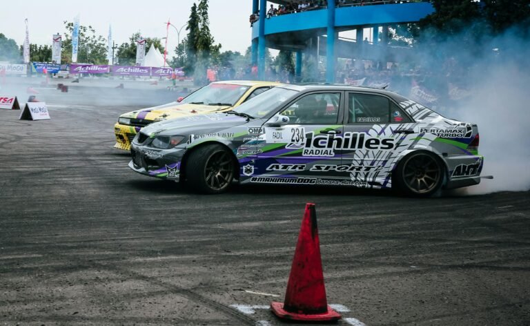 A thrilling scene of cars drifting on a speedway, showcasing motorsport action.